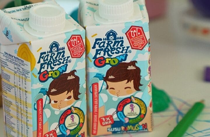 Two Farm Fresh Grow juice cartons with a cartoon girl on bright blue packaging side by side, showing cute kid-friendly design.