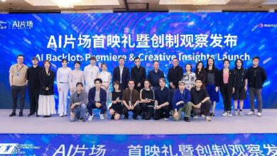 Group of about 25 people posing on a stage at an AI event, with a blue screen backdrop reading 'AI Backlot: Premiere & Creative Insights Launch' in English and Chinese.