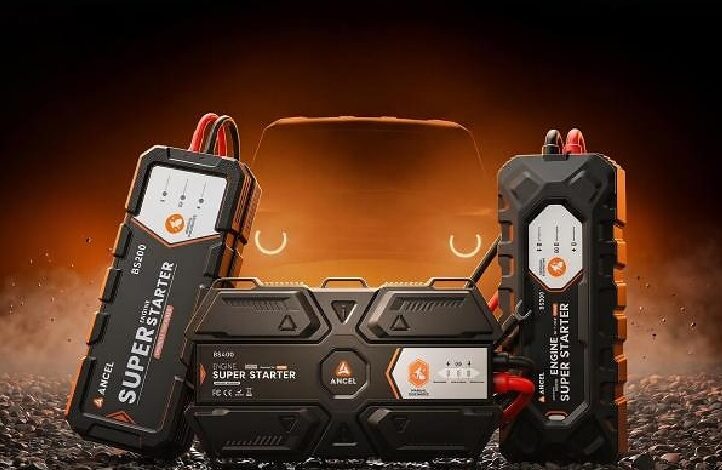 Portable car jump starter with dual battery packs on either side and a central control unit, glowing orange background.