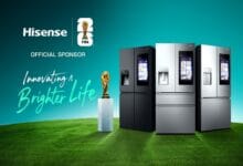 Hisense FIFA sponsorship banner with three modern refrigerators on a green field, a trophy, and the slogan 'Innovating a Brighter Life' on a teal background.] , Actually remove comma? Need proper JSON string.