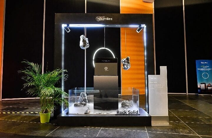 hoymiles batt - Wilayah.com.my Glass display with a neon-lit frame showing suspended and base rock samples, labeled 'Rock Solid' in a showroom setting