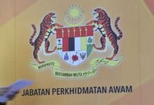Malaysia's Civil Service crest with two tigers, crescent and shield on a yellow background, beneath the 'Jabatan Perkhidmatan Awam' text