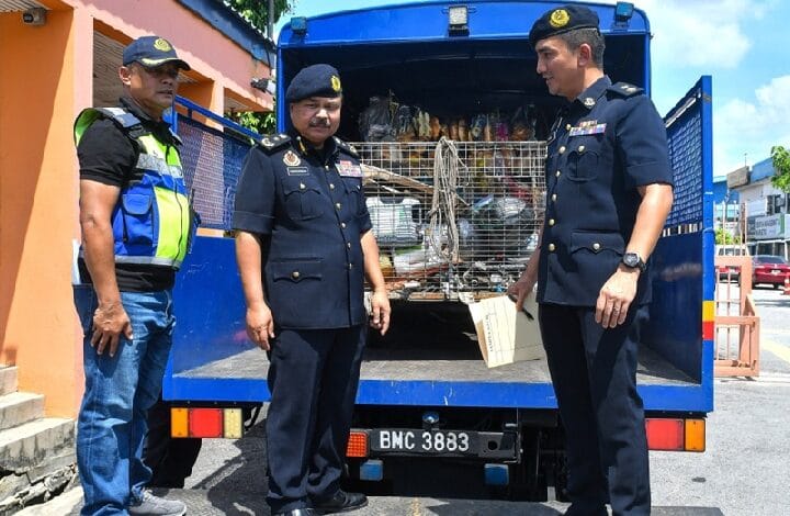 jpj selangor - Wilayah.com.my Three uniformed men stand beside an open blue truck loaded with metal cages and bags in the back.