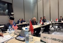 malaysia as iran - Wilayah.com.my International conference room with delegates seated at a long table, multiple national flags visible (Malaysia, Lebanon, Iran, Indonesia, Mozambique).