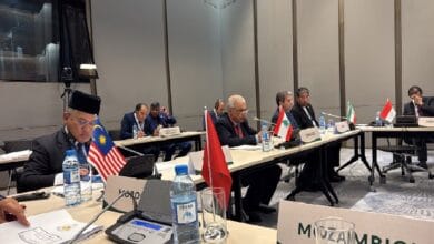 malaysia as iran - Wilayah.com.my International conference room with delegates seated at a long table, multiple national flags visible (Malaysia, Lebanon, Iran, Indonesia, Mozambique).