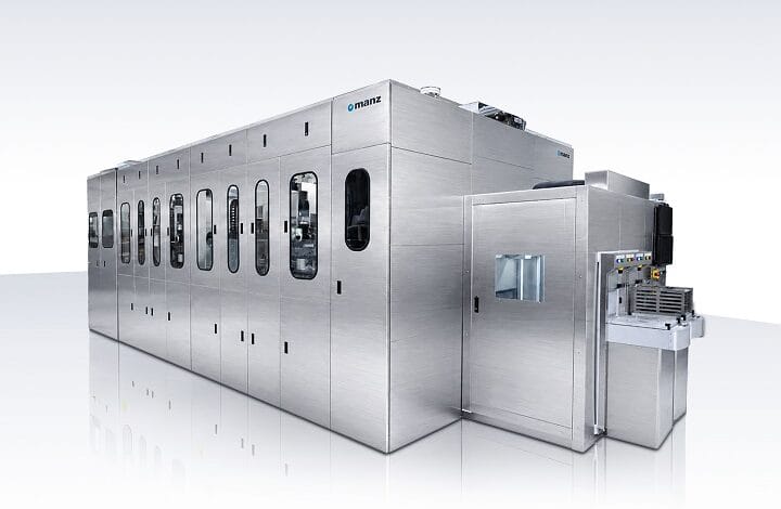 manz asia 2 - Wilayah.com.my Large stainless steel automated production line with multiple panel doors and windowed access points on a white reflective surface.
