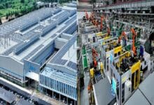 Split image of a factory district: solar-panel rooftop on a large building and a robot-driven manufacturing line indoors.