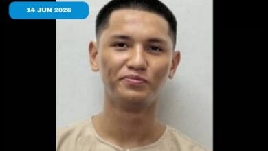 Mugshot-style portrait of a young man in a beige shirt against a gray background; blue date badge reads 14 JUN 2026.