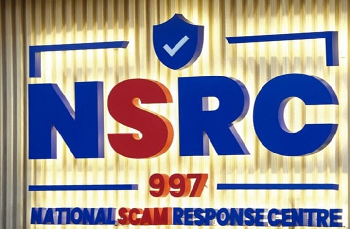 nsrc - Wilayah.com.my Sign for the National Scam Response Centre (NSRC) with 997, featuring blue and red letters and a blue shield with a checkmark on a gold background.