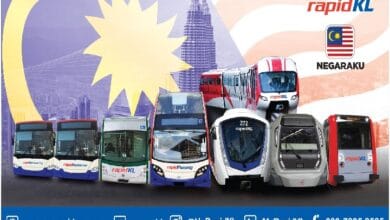 rapid kl digital - Wilayah.com.my Fleet of rapidKL buses lined up with Kuala Lumpur skyline and Petronas Towers in the background, featuring branding and contact info on a promotional banner.