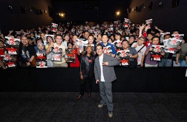 the furious 2 - Wilayah.com.my Two men stand center-stage posing for a photo as a large, excited crowd fills the dark theater behind them, holding up posters and making peace signs.