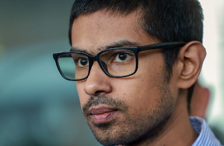 yusoff rawther - Wilayah.com.my Close-up portrait of a man wearing black rectangular glasses, looking thoughtful to the left.
