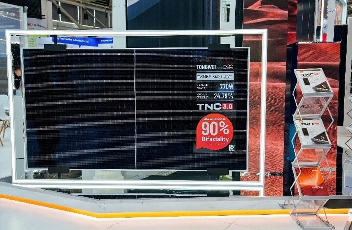 bifacial - Wilayah.com.my Large solar panel display at an expo booth, framed by a white illuminated frame, showing 'TNC 3.0' and a red '90% Bifaciality' badge.