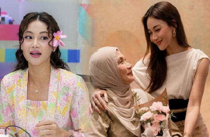 Three women share a warm moment: a young woman with a flower in her hair on the left, an elderly woman in a beige hijab in the middle, and another smiling woman on the right holding a bouquet.