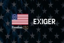 exiger 2 - Wilayah.com.my Graphic showing a US flag square with 'Freedom 250' next to the word 'EXIGER' on a dark starry background.