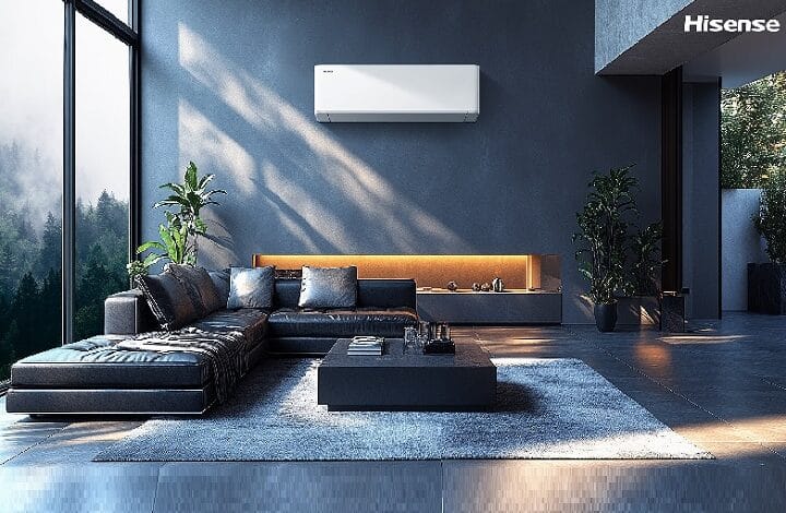 hisense - Wilayah.com.my Modern living room with a wall-mounted Hisense air conditioner, dark blue walls, and a black leather sectional sofa.