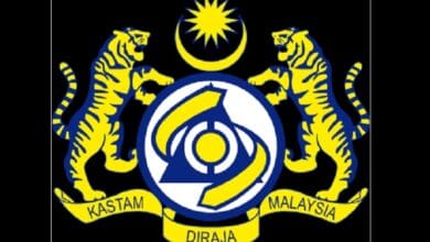 kastam - Wilayah.com.my Royal Malaysian Customs crest with two yellow tigers, crescent moon and star above, and Kastam Diraja Malaysia banner.