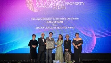 Six people in formal attire on stage receiving a trophy at The Edge Best Managed & Sustainable Property Awards 2026.