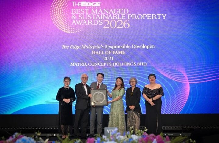 Six people in formal attire on stage receiving a trophy at The Edge Best Managed & Sustainable Property Awards 2026.