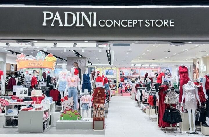 padini - Wilayah.com.my Storefront sign: PADINI CONCEPT STORE and view into a brightly lit apparel shop with mannequins and clothing displays inside.