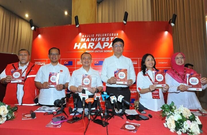 ph - Wilayah.com.my Six people stand behind a red table at a press conference, each holding a booklet titled 'Manifesto Harapan'.