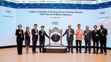 Group of ten executives posing with a ceremonial gong on stage during the listing ceremony for Stratus Global Holdings Berhad at Bursa Malaysia Main Market, July 21, 2026.