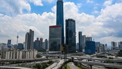 trx exchange 2 - Wilayah.com.my City skyline with tall skyscrapers and a complex network of curved elevated highways below.