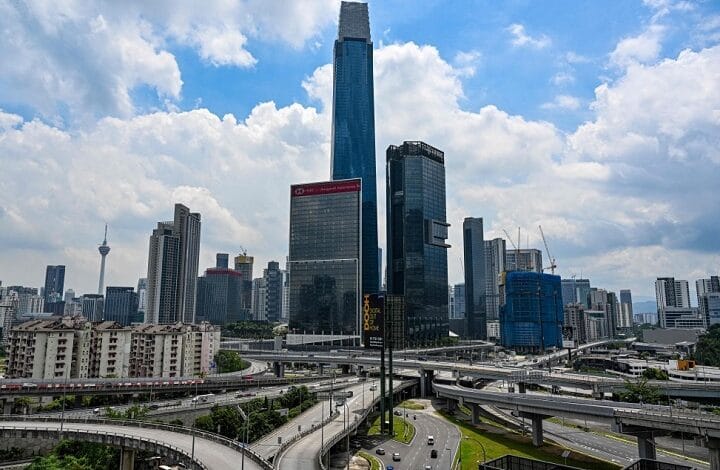 trx exchange 2 - Wilayah.com.my City skyline with tall skyscrapers and a complex network of curved elevated highways below.